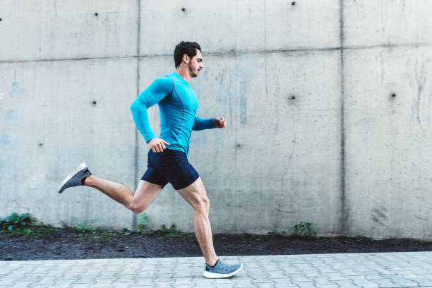 man running in front of concrete wall